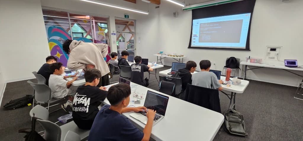 Students coding together in class